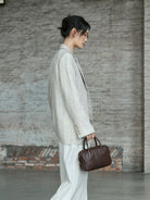 QIUZHEN Vegetable Tanned Leather Bowling Bag in Brown - On Female Model