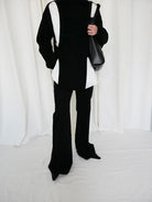 RARELY ALIKE Curved Seam Denim Flare Jeans in Black - On Model