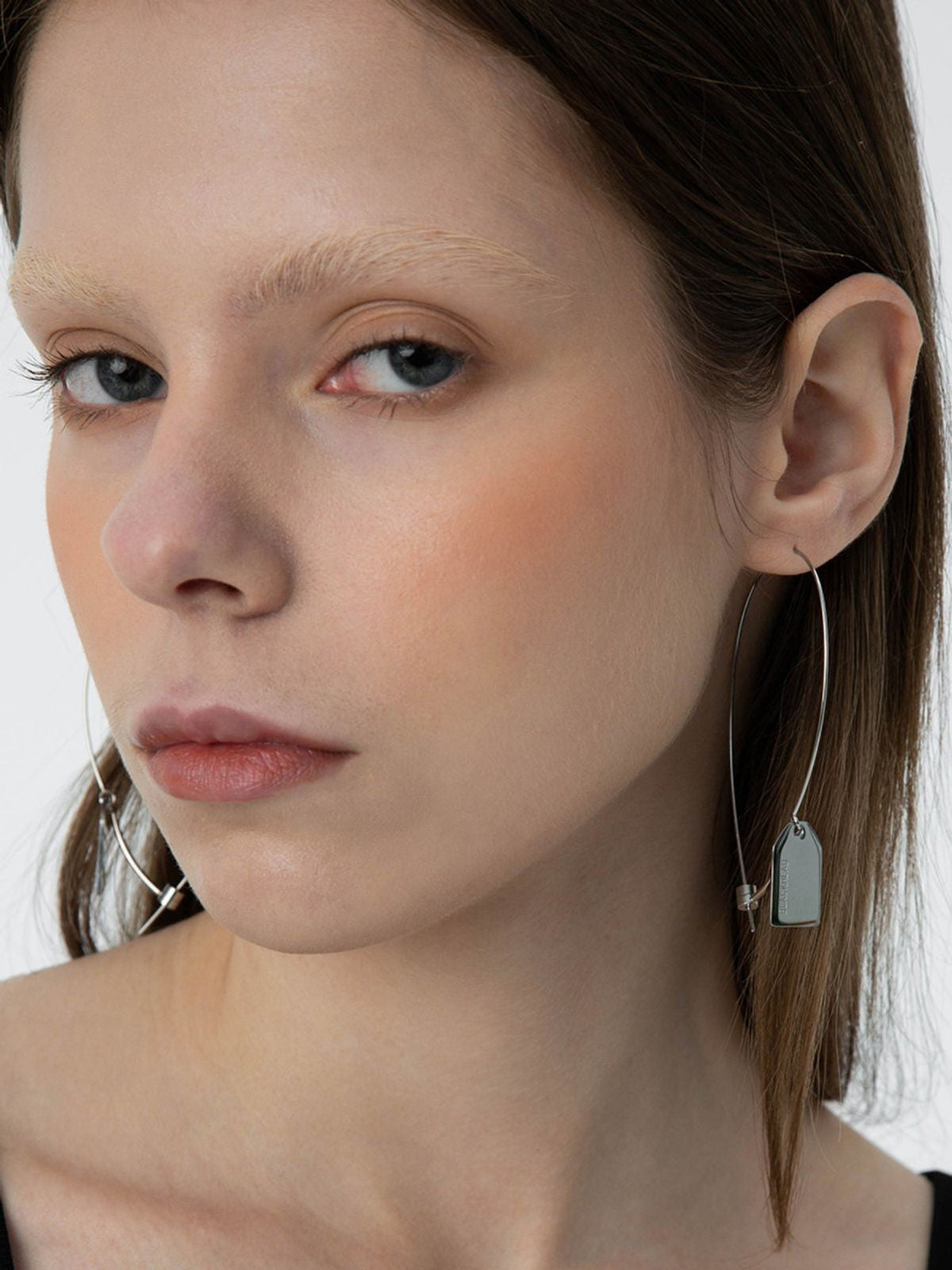 BLACKHEAD Steel Label Tag Wire Earrings in Gray - On Female Model