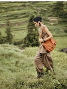 QIUZHEN Vegetable Tanned Leather Messenger Bag in Brown - On Female Model