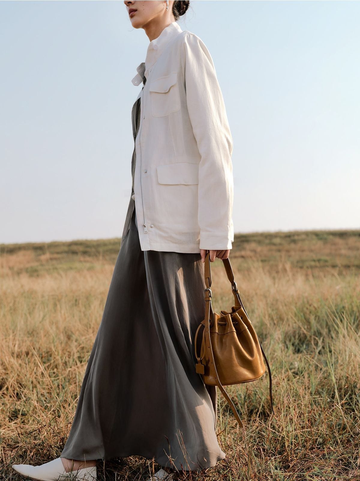 QIUZHEN Kidskin Drawstring Bucket Bag in Brown - On Female Model