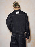 MEDM Embroidered Cuff Raw Denim Jacket in Blue - On Model
