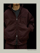 USAGE Crinkle Nylon Hooded Track Jacket in Brown - On Male Model