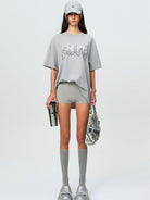 SMFK Metallic Logo Cotton T Shirt in Gray - On Female Model