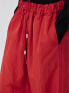 SIMPLE PROJECT Pleated Wide Leg Nylon Pants in Red - On Model