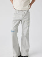 SIMPLE PROJECT Patchwork Distressed Flared Jeans in White - On Male Model