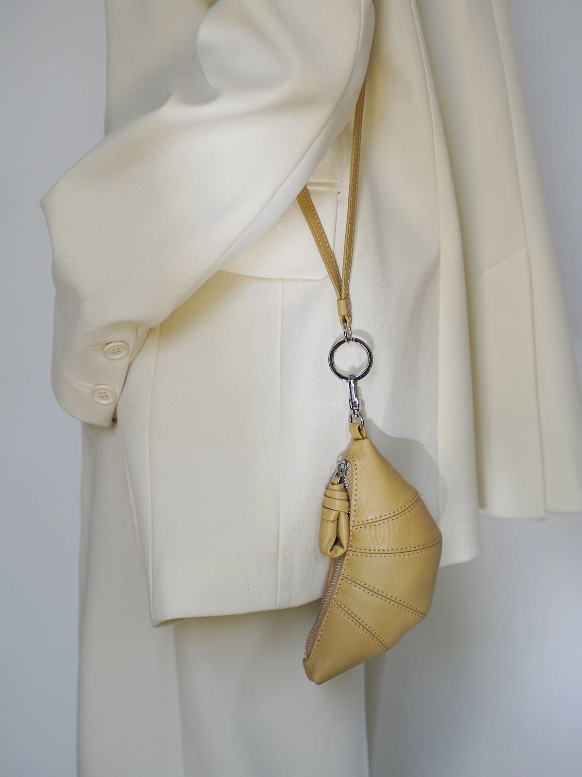 PANLULUPAN Pebbled Leather Croissant Coin Purse in Cream - On Model
