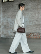 QIUZHEN Vegetable Tanned Leather Bowling Bag in Brown - On Female Model