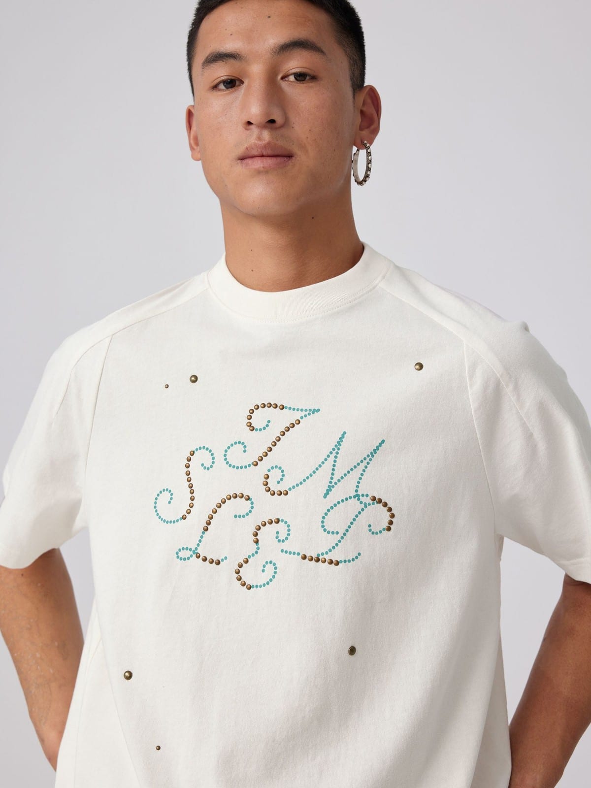 SIMPLE PROJECT Brass Stud Retro Logo Cotton T Shirt in White - On Male Model