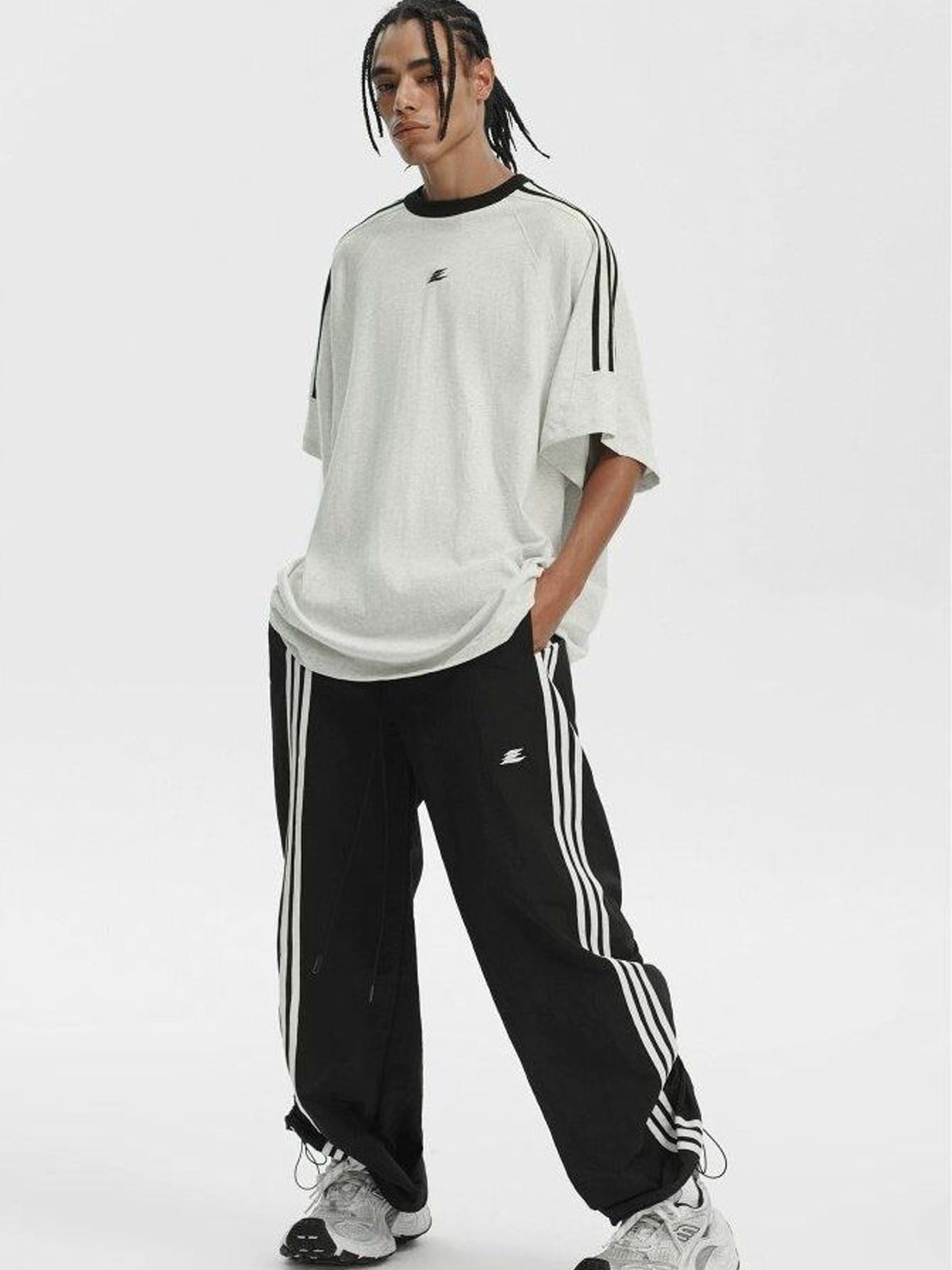 LOSTCTRL Ruched Asymmetrical Striped Track Pants in Black - On Male Model