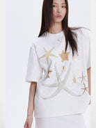 THELIGHT OFFICIAL Rhinestone Starfish Motif T Shirt in White - On Female Model