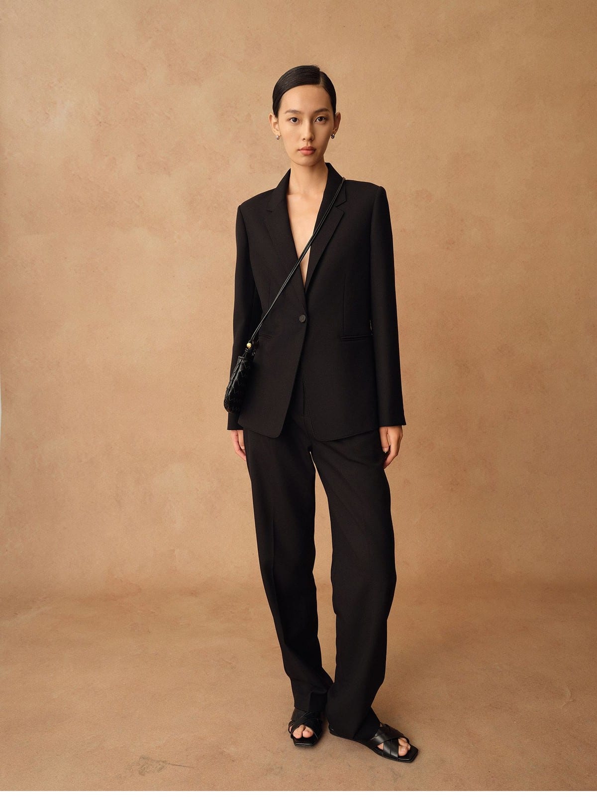 TEASEL Merino Wool Pleated Trousers in Black - On Female Model