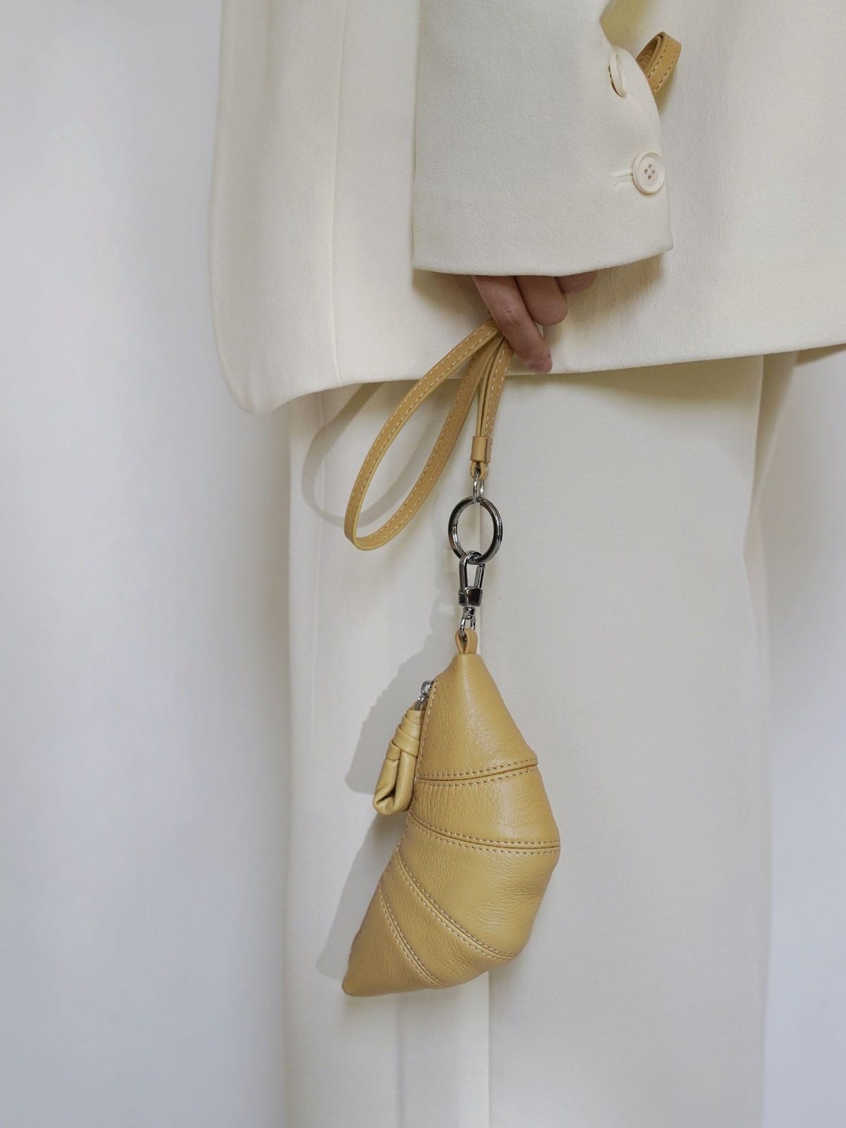 PANLULUPAN Pebbled Leather Croissant Coin Purse in Cream - On Female Model