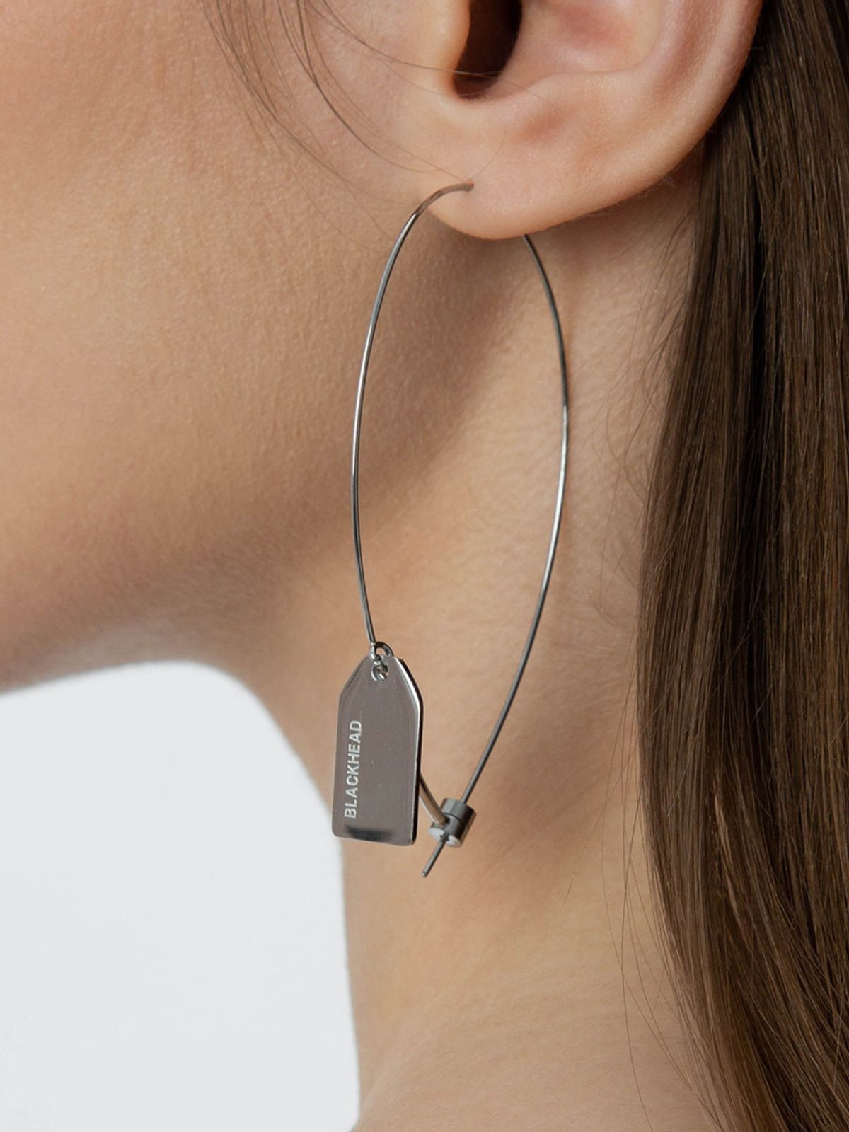BLACKHEAD Steel Label Tag Wire Earrings in Gray - On Female Model