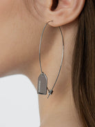 BLACKHEAD Steel Label Tag Wire Earrings in Gray - On Female Model