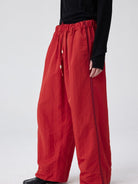 SIMPLE PROJECT Pleated Wide Leg Nylon Pants in Red - On Model