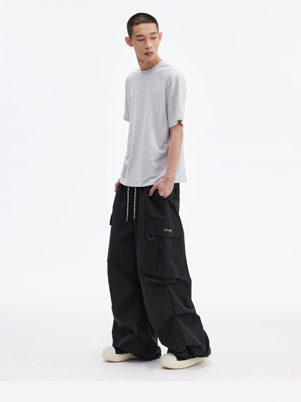 MEDM Multi Pocket Parachute Cargo Pants in Black - On Male Model