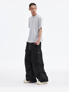 MEDM Multi Pocket Parachute Cargo Pants in Black - On Male Model