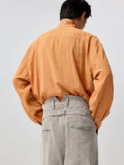 SIMPLE PROJECT Lyocell Ramie Pleated V Neck Shirt in Orange - On Model