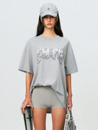 SMFK Metallic Logo Cotton T Shirt in Gray - On Female Model