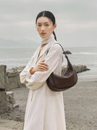 QIUZHEN Vegetable Tanned Leather Crescent Bag in Brown - On Female Model