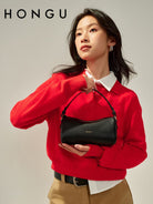 HONGU Leather Crossbody Pillow Bag in Black - On Female Model