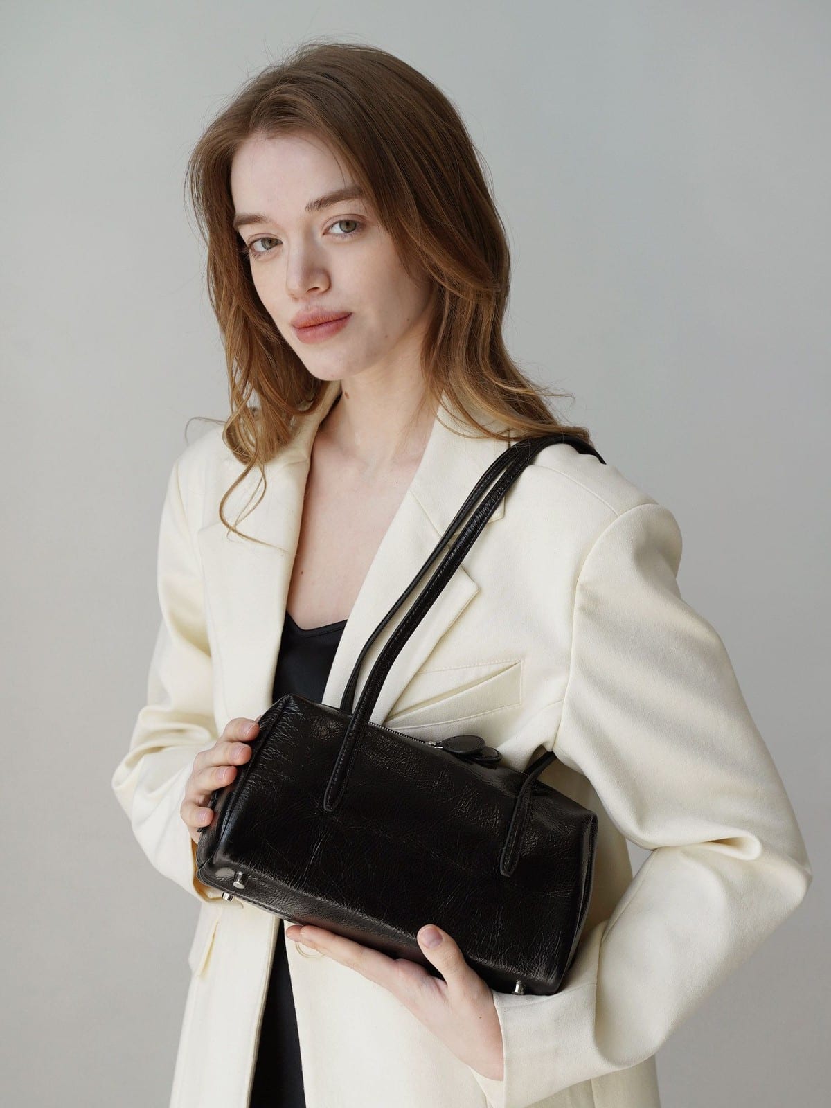 PANLULUPAN Oil Wax Leather Pillow Shoulder Bag in Cream - On Female Model