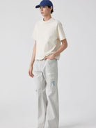 SIMPLE PROJECT Patchwork Distressed Flared Jeans in White - On Male Model