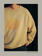 USAGE Washed Cotton Raglan Smiley Sweatshirt in Beige - On Model