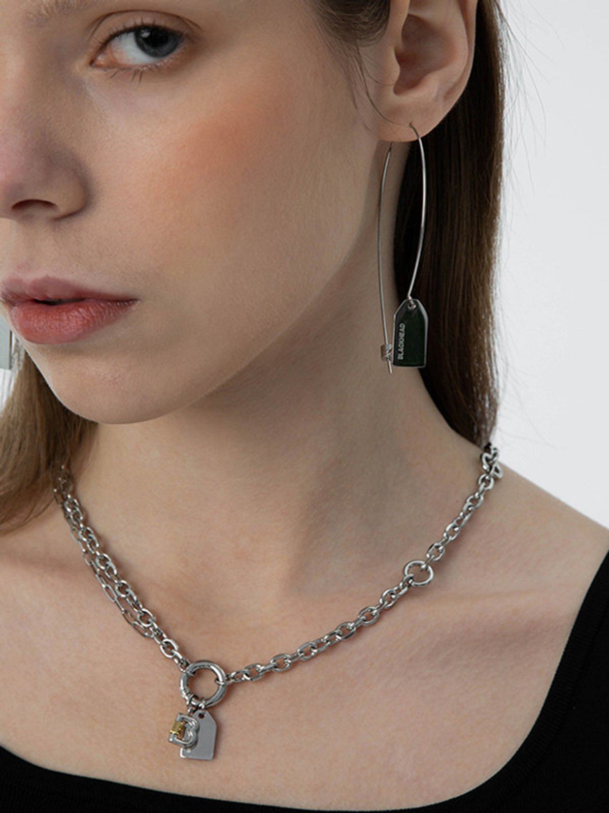 BLACKHEAD Steel Label Tag Wire Earrings in Gray - On Female Model