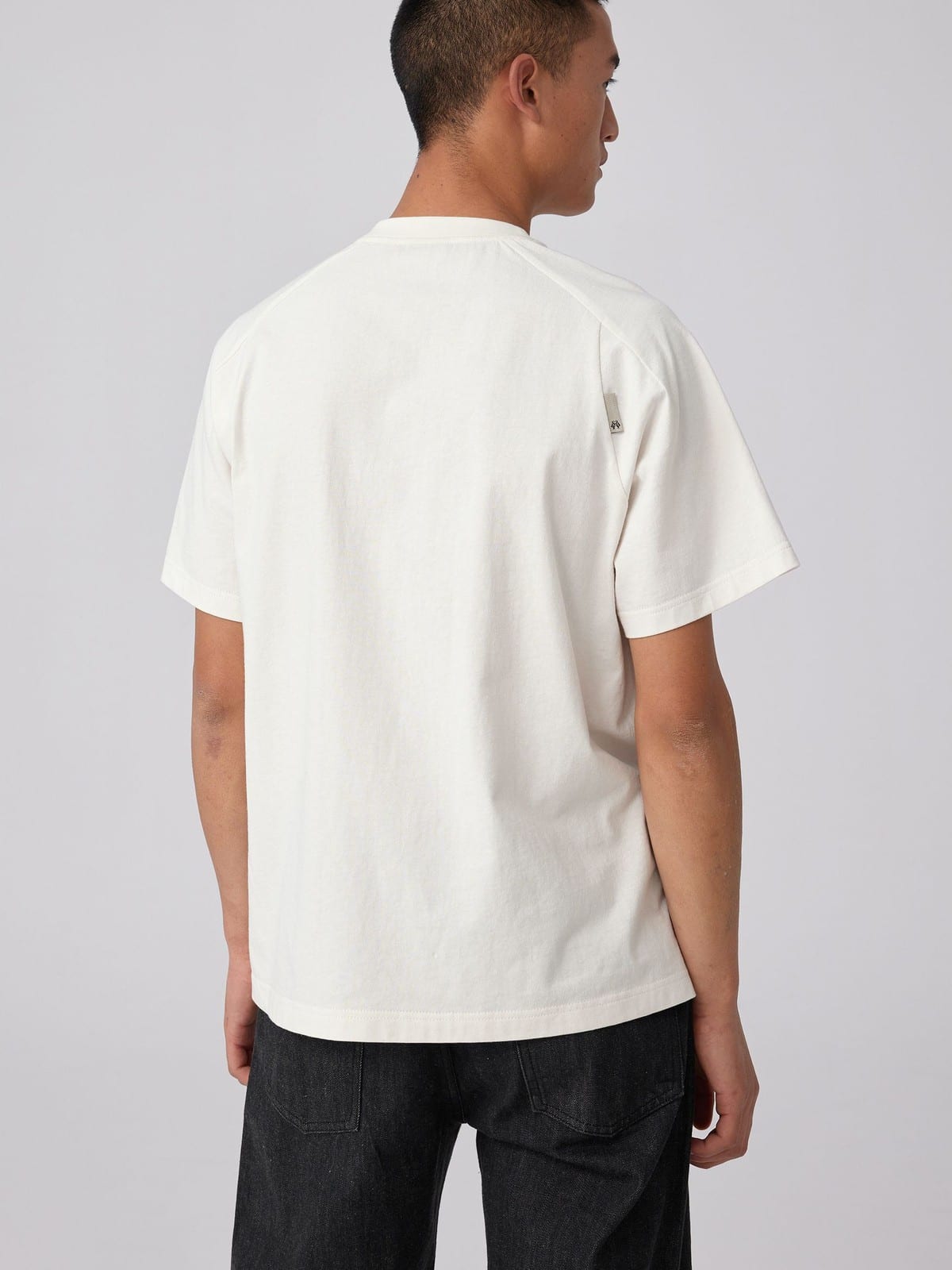 SIMPLE PROJECT Brass Stud Retro Logo Cotton T Shirt in White - On Male Model