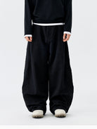 MEDM Embroidered Cotton Cargo Pants in Black - On Model