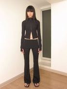 RARELY ALIKE Low Rise Layered Flared Yoga Pants in Black - On Female Model