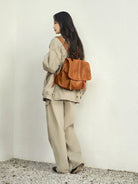 QIUZHEN Vegetable Tanned Goatskin Messenger Backpack in Brown - On Female Model