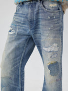 SIMPLE PROJECT Distressed Patchwork Flared Jeans in Blue - On Model