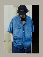 USAGE Distressed Short Sleeve Denim Shirt in Denim - On Male Model