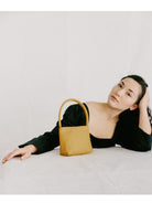 PANLULUPAN Waxed Cowhide Square Shoulder Bag in Yellow - On Female Model