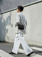 QIUZHEN Vintage Leather Envelope Crossbody in Black - On Female Model