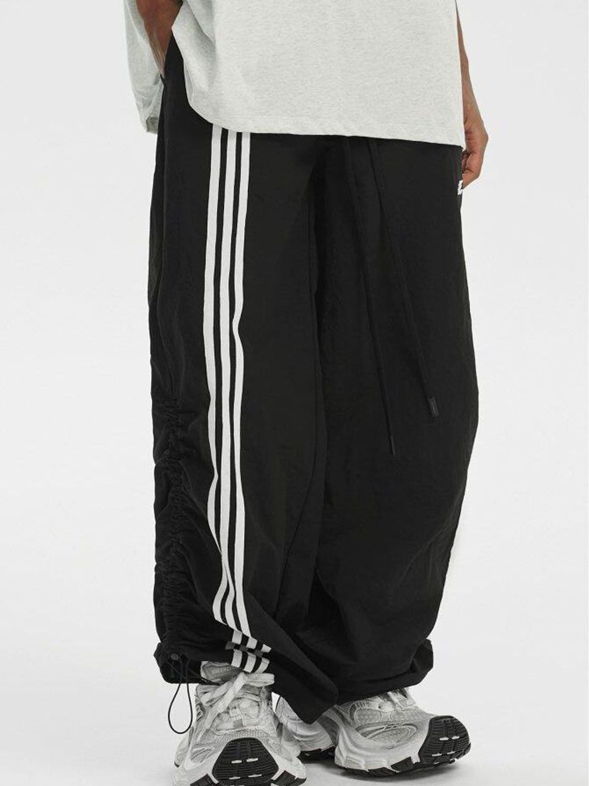 LOSTCTRL Ruched Asymmetrical Striped Track Pants in Black - On Model
