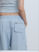 RARELY ALIKE Cropped Cotton Lantern Cargo Shorts in Sky Blue - On Female Model