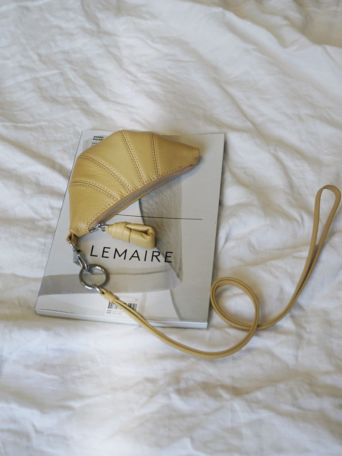 PANLULUPAN Pebbled Leather Croissant Coin Purse in Cream - Lifestyle