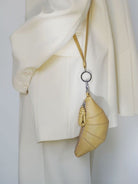 PANLULUPAN Pebbled Leather Croissant Coin Purse in Cream - On Model