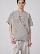 SIMPLE PROJECT Brass Stud Retro Logo Cotton T Shirt in Gray - On Male Model