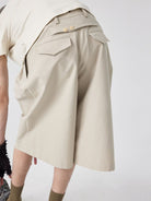 SIMPLE PROJECT Cotton Pleated Cropped Shorts in Beige - On Model