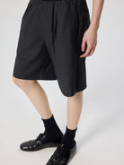 SIMPLE PROJECT Logo Tape Wool Blend Shorts in Gray - On Male Model