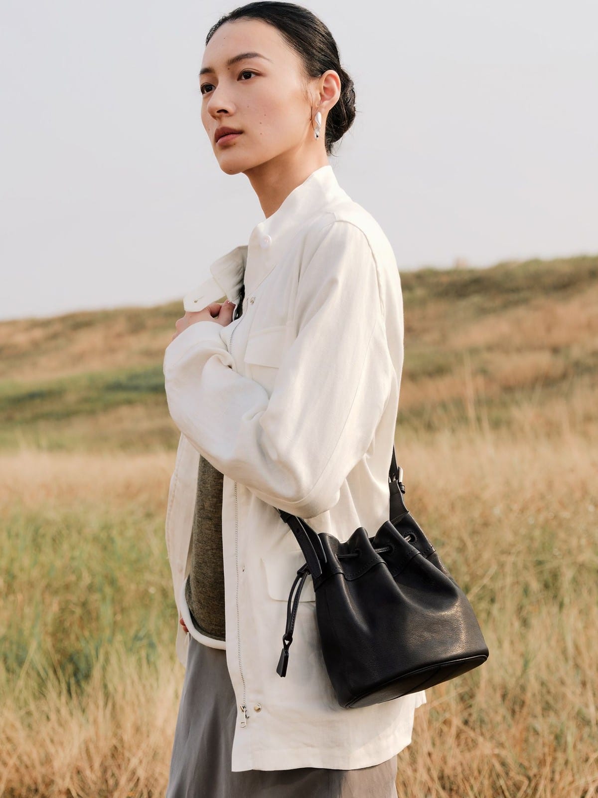 QIUZHEN Kidskin Drawstring Bucket Bag in Black - On Female Model
