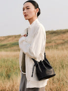 QIUZHEN Kidskin Drawstring Bucket Bag in Black - On Female Model