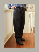 USAGE Heavily Washed Selvedge Denim Jeans in Black - On Male Model