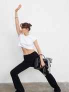 MADEINAM Fold Over Waist Flared Stretch Pants in Black - On Female Model