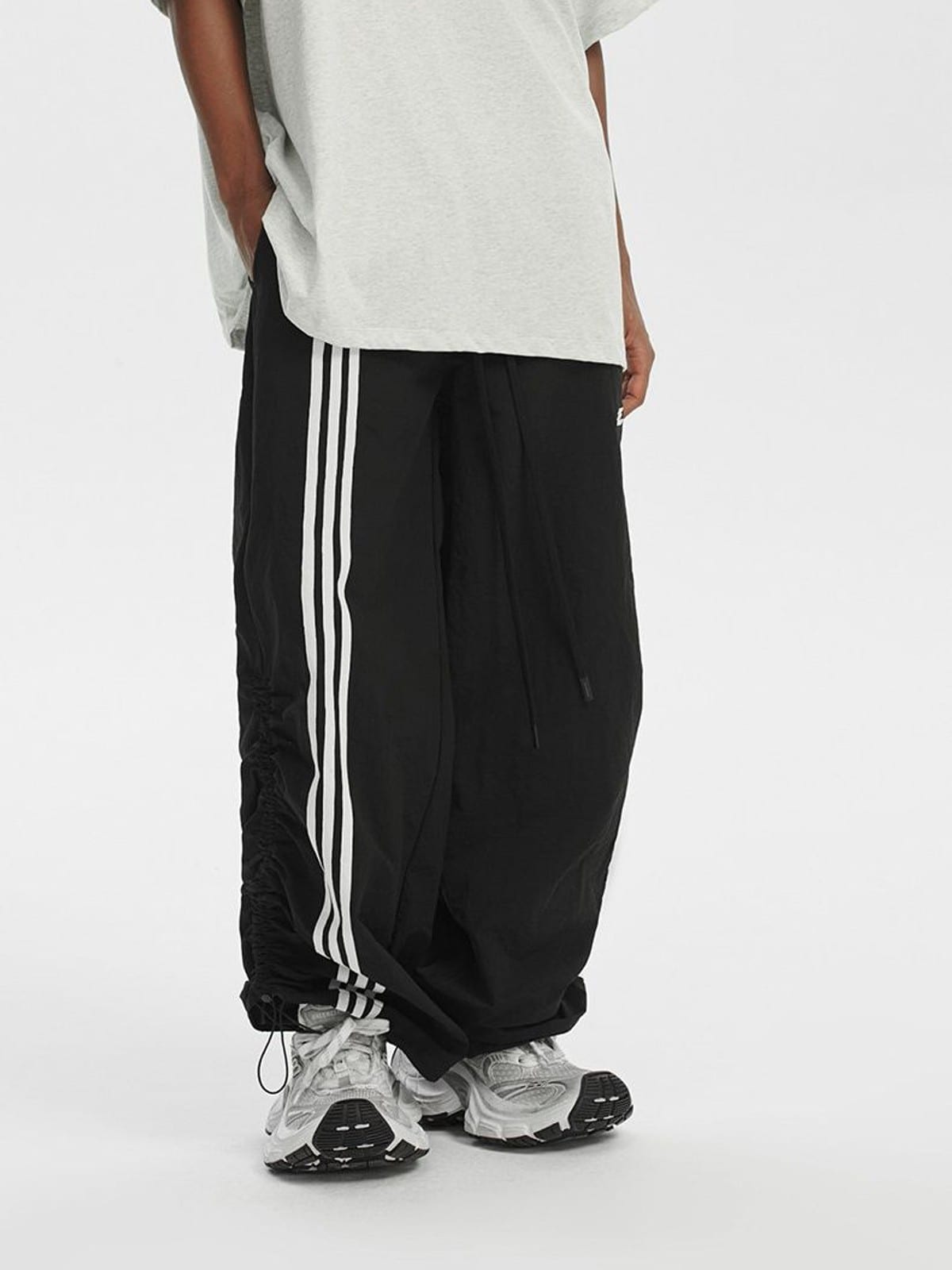 LOSTCTRL Ruched Asymmetrical Striped Track Pants in Black - On Model